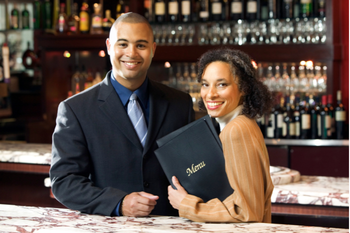 Host and hostess behind counter