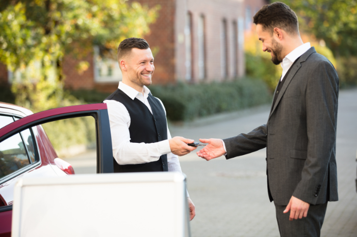 Valet parking attendant taking keys from driver