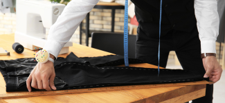 Tailor measuring pants on a table