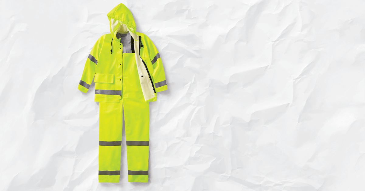 A yellow waterproof jacket and bib pants with reflective silver stripes, representing the critical Outer Shell layer required for ANSI/OSHA cold stress prevention and outdoor work safety.