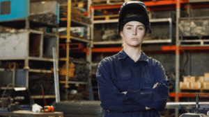 ndustrial worker wearing flame resistant (FR) protective clothing while performing a workplace hazard assessment for electrical and flash fire risks.