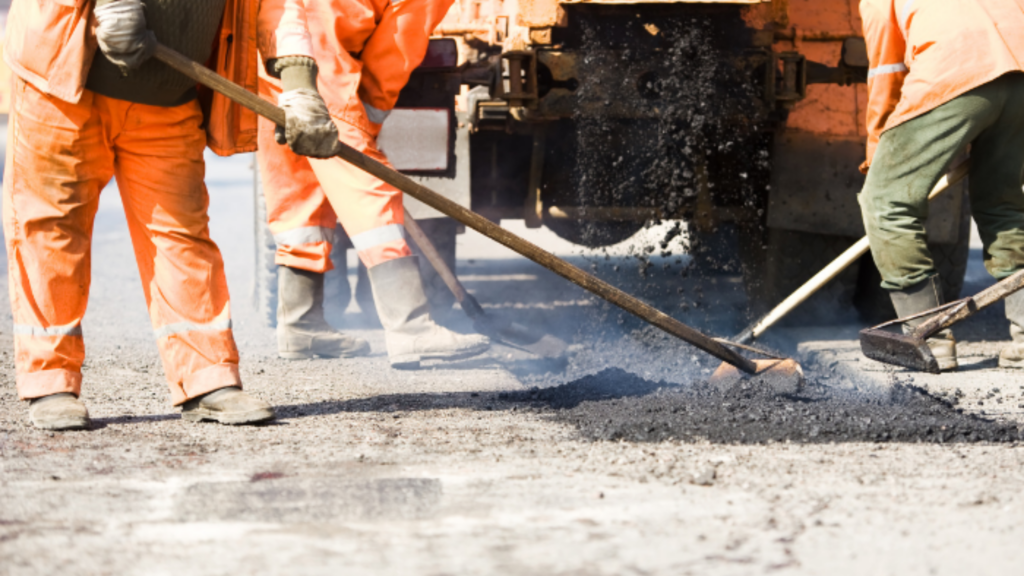 Worker in flame-resistant and hi-vis safety uniform representing OSHA compliance in a managed uniform program
