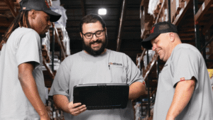 Business owner reviewing uniform rental contract terms before transitioning to a managed uniform program